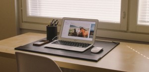 Open laptop on a desk in front of a window