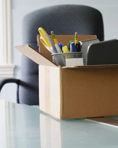 Box on office desk with office supplies in it
