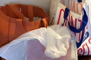 Bags of paper to shred and recycle collected while organizing paperwork in home office