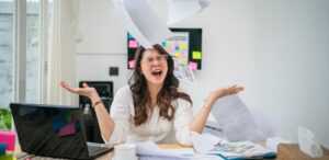 Woman surrounded by flying papers